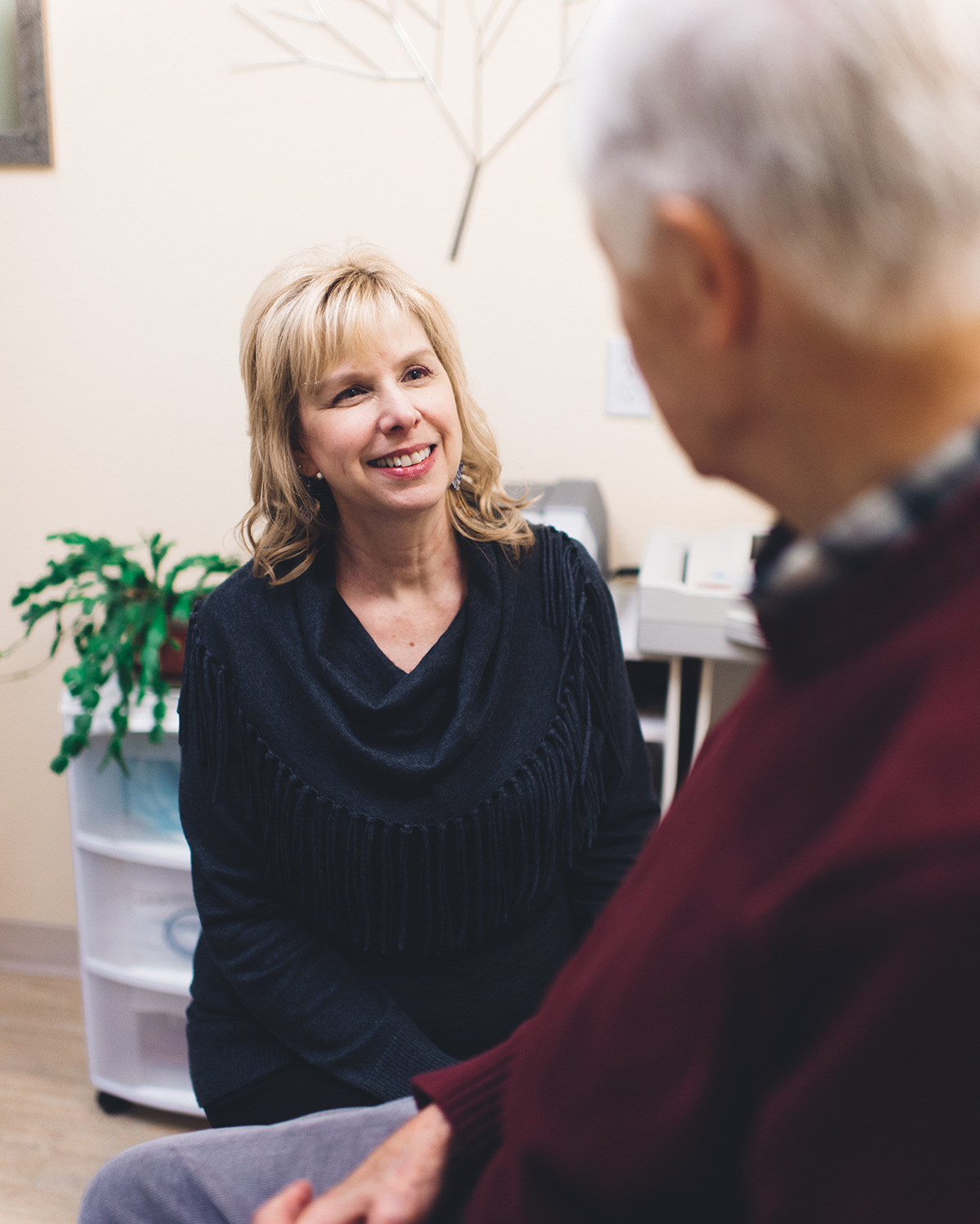 Working together to help you Dr. Wendy Schilling working with patient in doctor office.