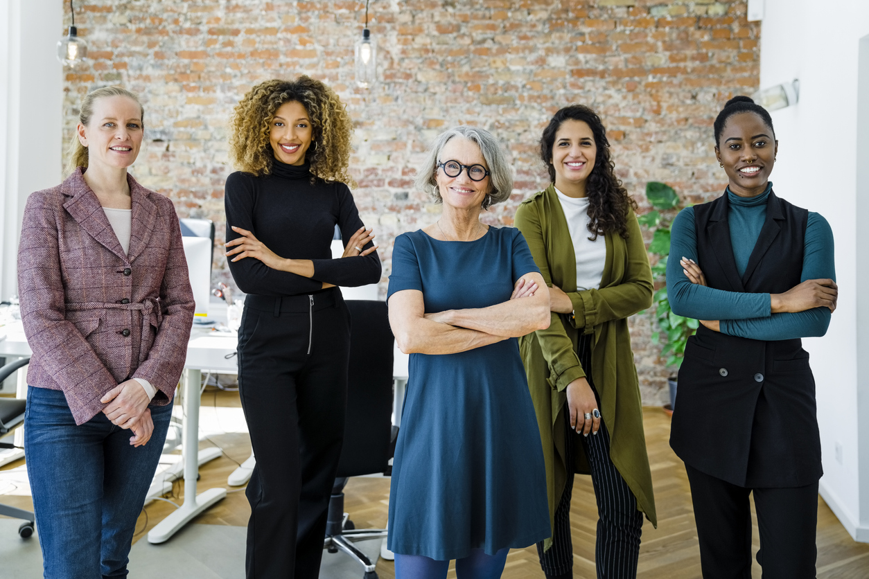 Portrait of successful female business team in office Multiracial business group standing together in the office.